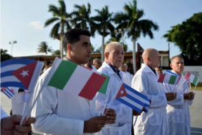Doctors and nurses of Cuba's Henry Reeve International Medical Brigade are bid farewell before they travel to hard-hit Italy to help in the fight against the coronavirus COVID-19 pandemic, at the Central Unit of Medical Cooperation in Havana, on March 21. Cuba has dispatched medical personnel to dozens of countries around the world in hopes of helping to ease a global crisis that has already killed nearly 20,000 people around the world. Doctors and nurses of Cuba's Henry Reeve International Medical Brigade are bid farewell before they travel to hard-hit Italy to help in the fight against the coronavirus COVID-19 pandemic, at the Central Unit of Medical Cooperation in Havana, on March 21. Cuba has dispatched medical personnel to dozens of countries around the world in hopes of helping to ease a global crisis that has already killed nearly 20,000 people around the world.