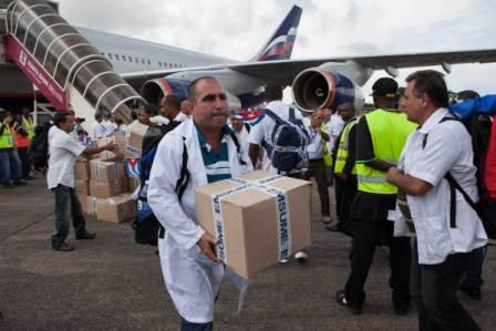 The first members of a team of 165 Cuban doctors and health workers unload boxes of medicines and medical material from a plane upon their arrival at Freetown's airport to help the fight against Ebola in Sierra Leone, on October 2, 2014.